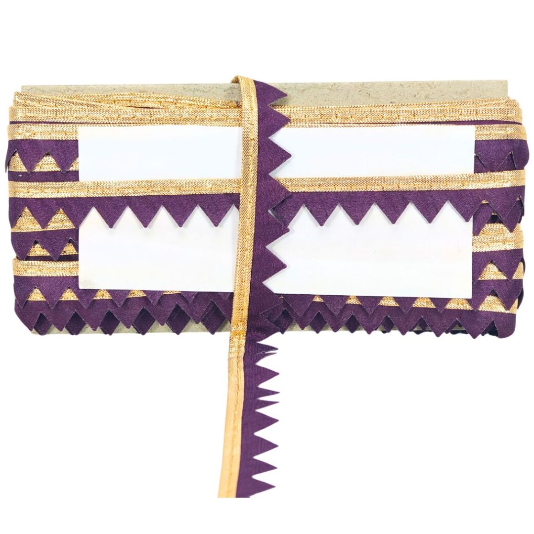 Purple and gold patterned clutch bag on a white background
