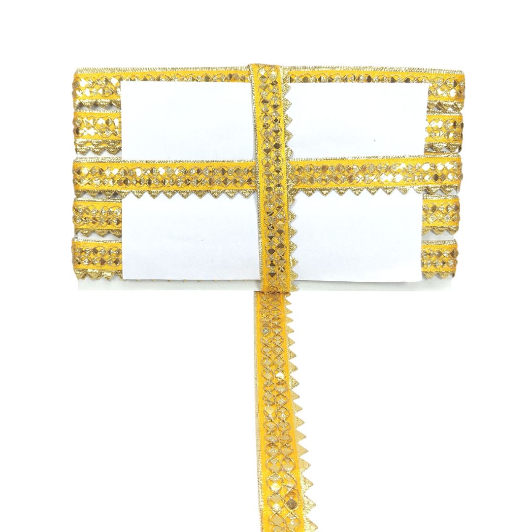 Gold decorative cross with intricate details on a white background