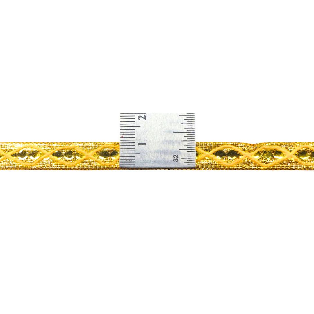 Gold lace trim with a ruler for measurement on a white background