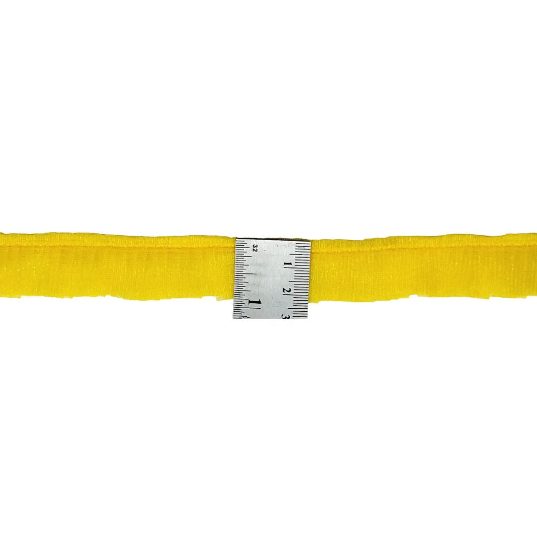 Yellow belt with a ruler for scale on a white background