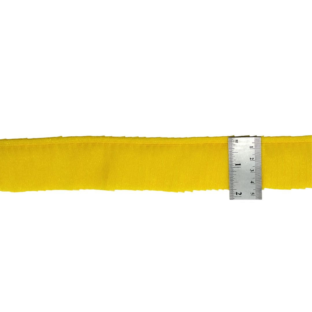 Yellow fabric strip with a ruler for measurement on a white background