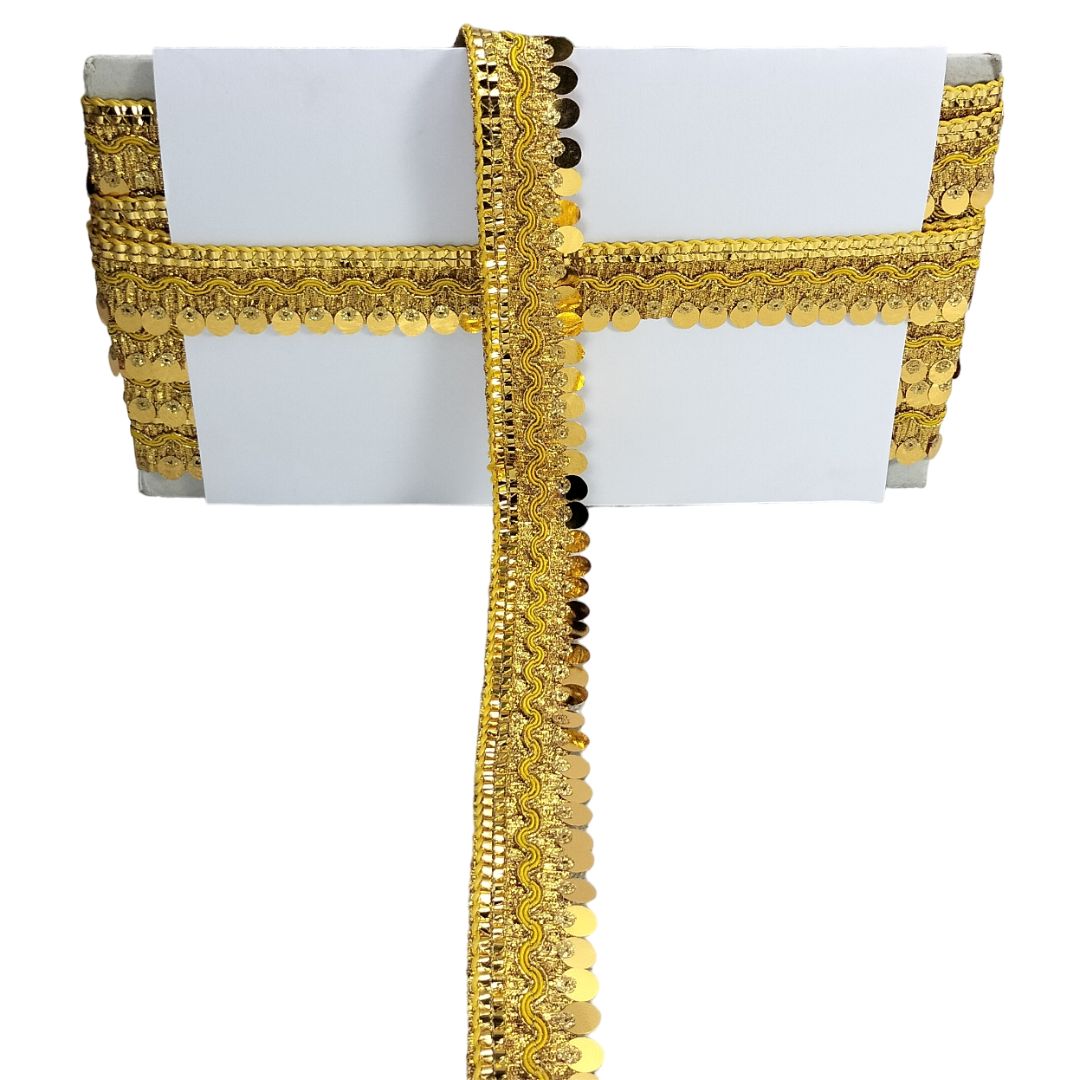 White tablecloth with gold lace trim on a white background