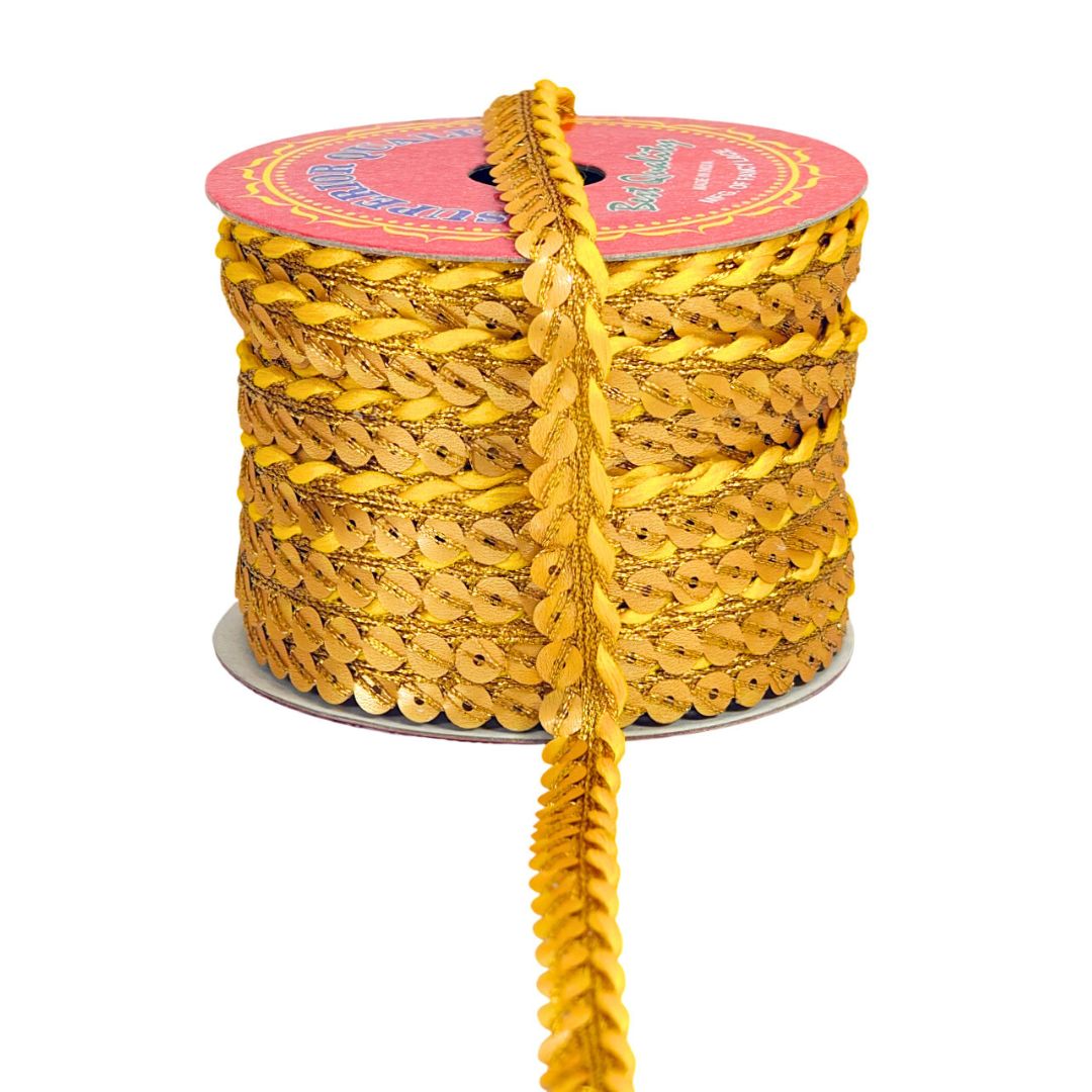 Spool of yellow sequin ribbon with a pink label on a white background