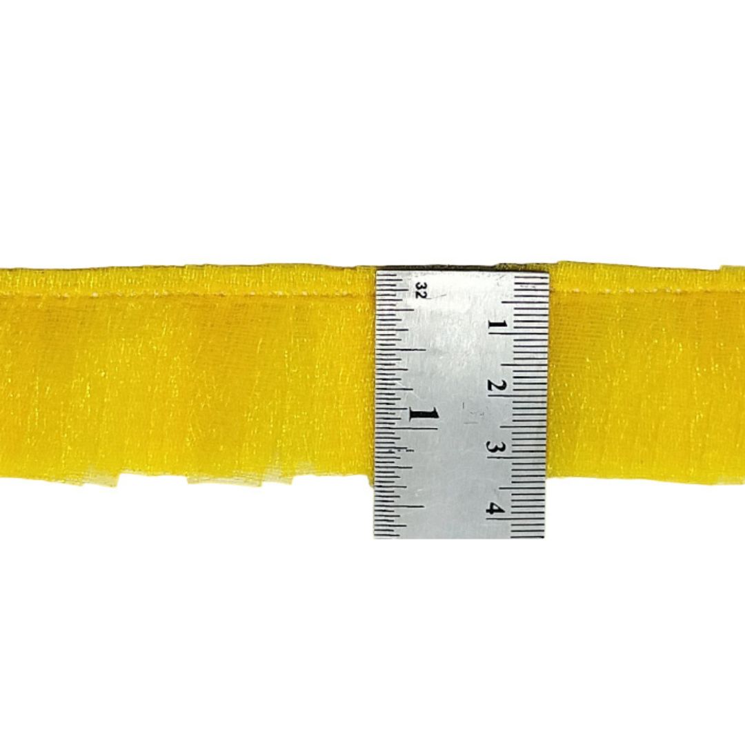 Yellow ribbon with a ruler for measurement on a white background