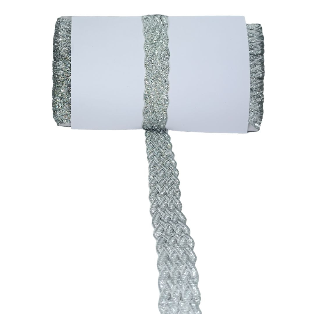 White napkin with silver woven trim on a white background