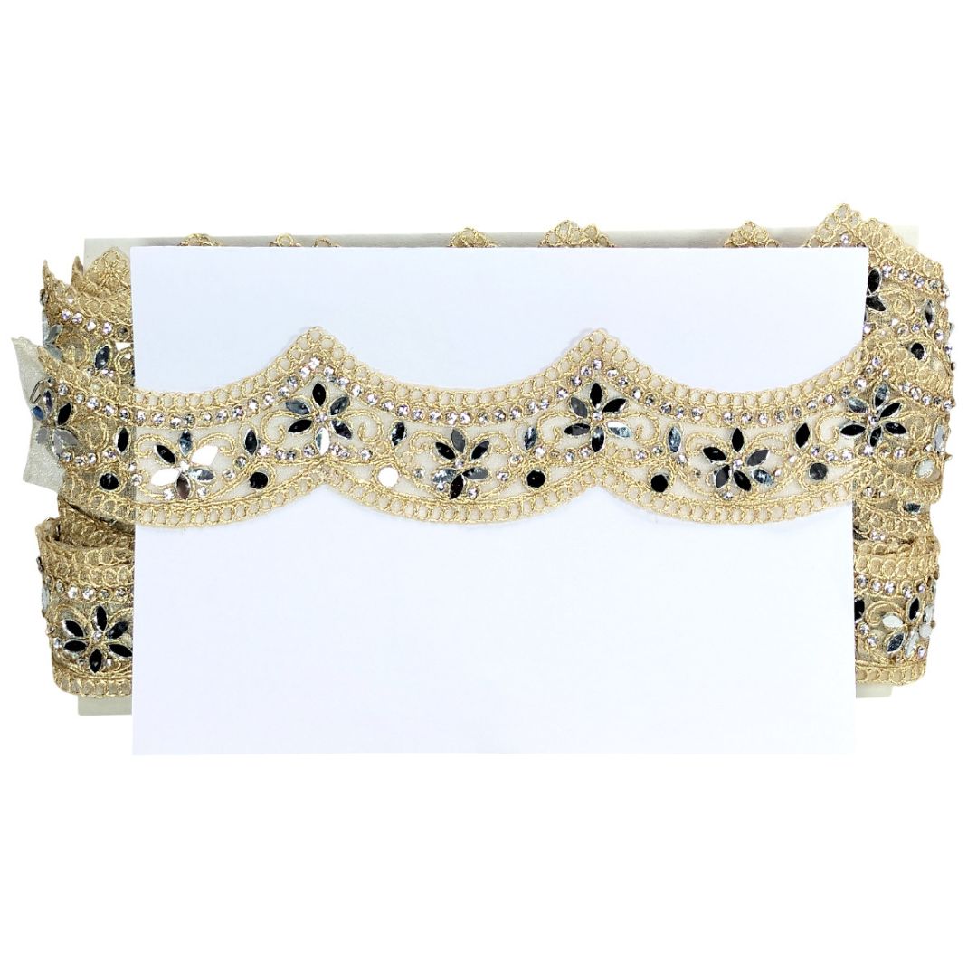 Decorative headband with gold and black embellishments on a white background