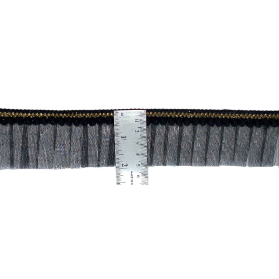 Strip of black and gray fabric with a ruler for scale on a white background