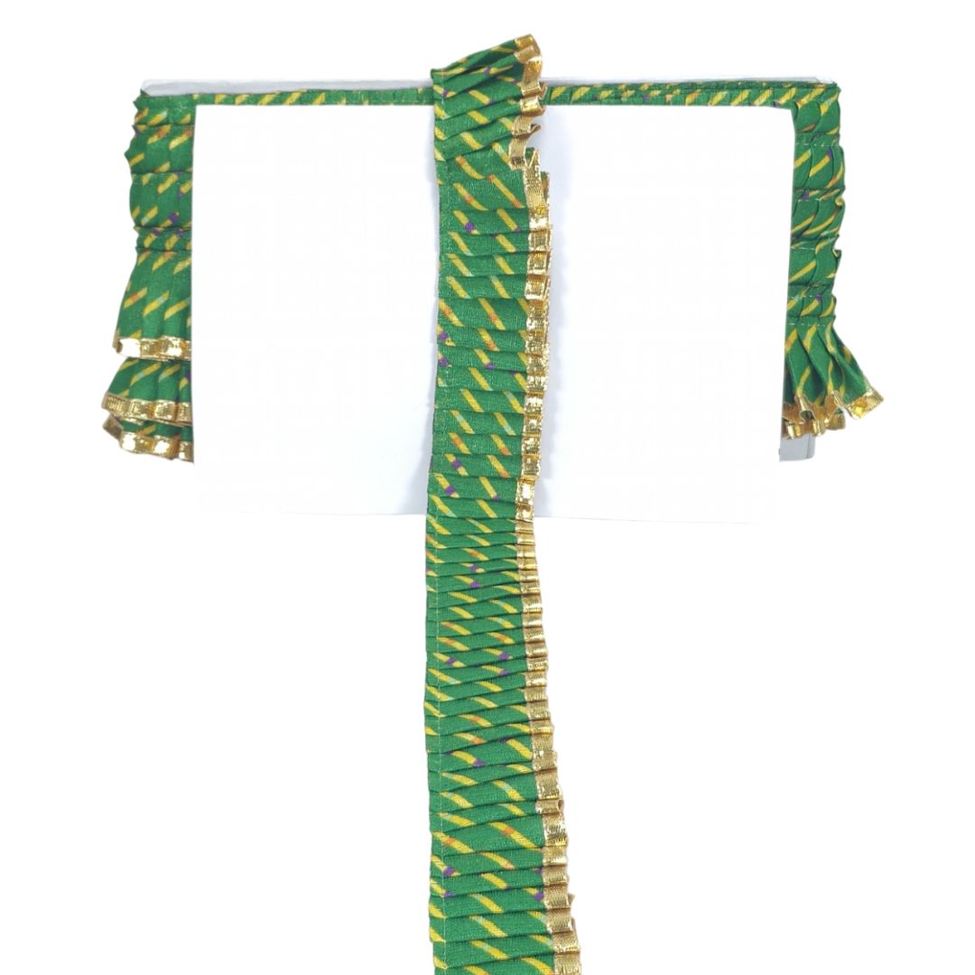 Green and gold decorative fabric on a white background