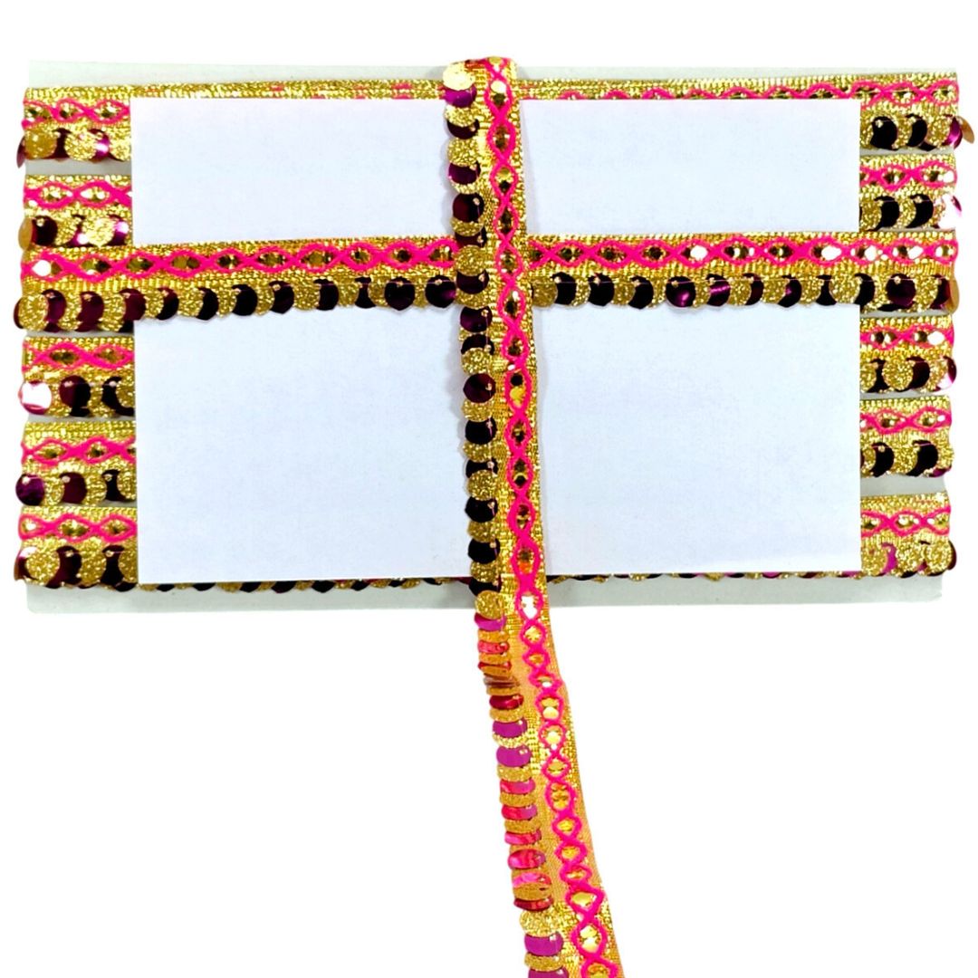 Decorative clutch with gold, pink, and black embellishments on a white background