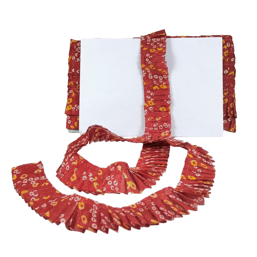 Red patterned fabric with a white center on a white background