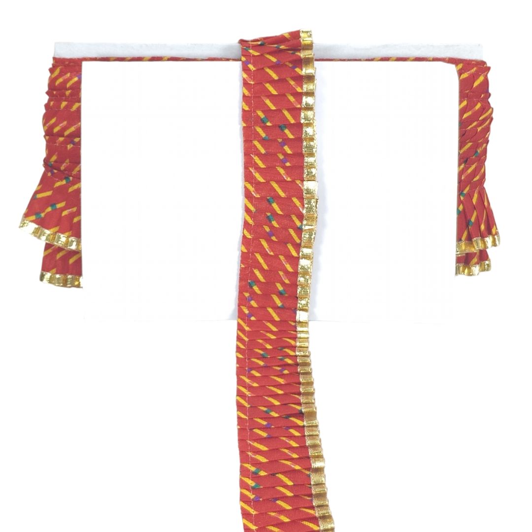Red and gold fabric with decorative patterns on a white background