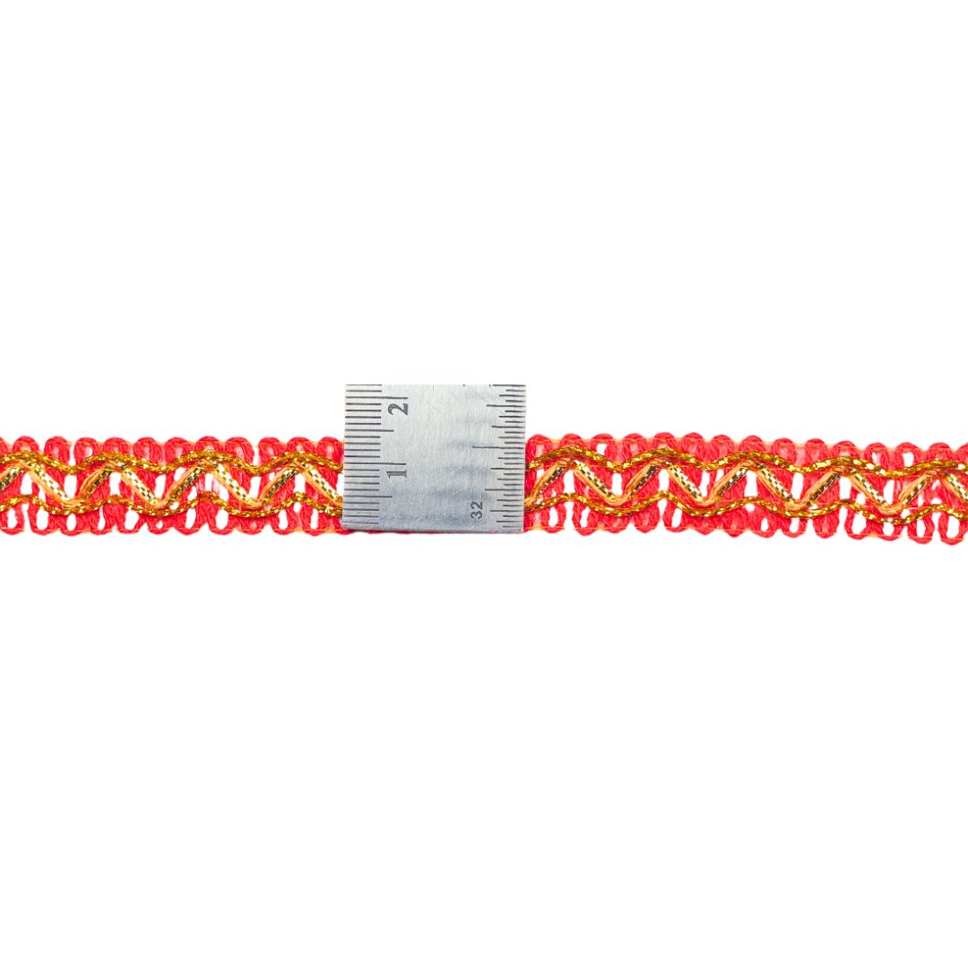 Red and gold braided trim with a ruler for scale on a white background