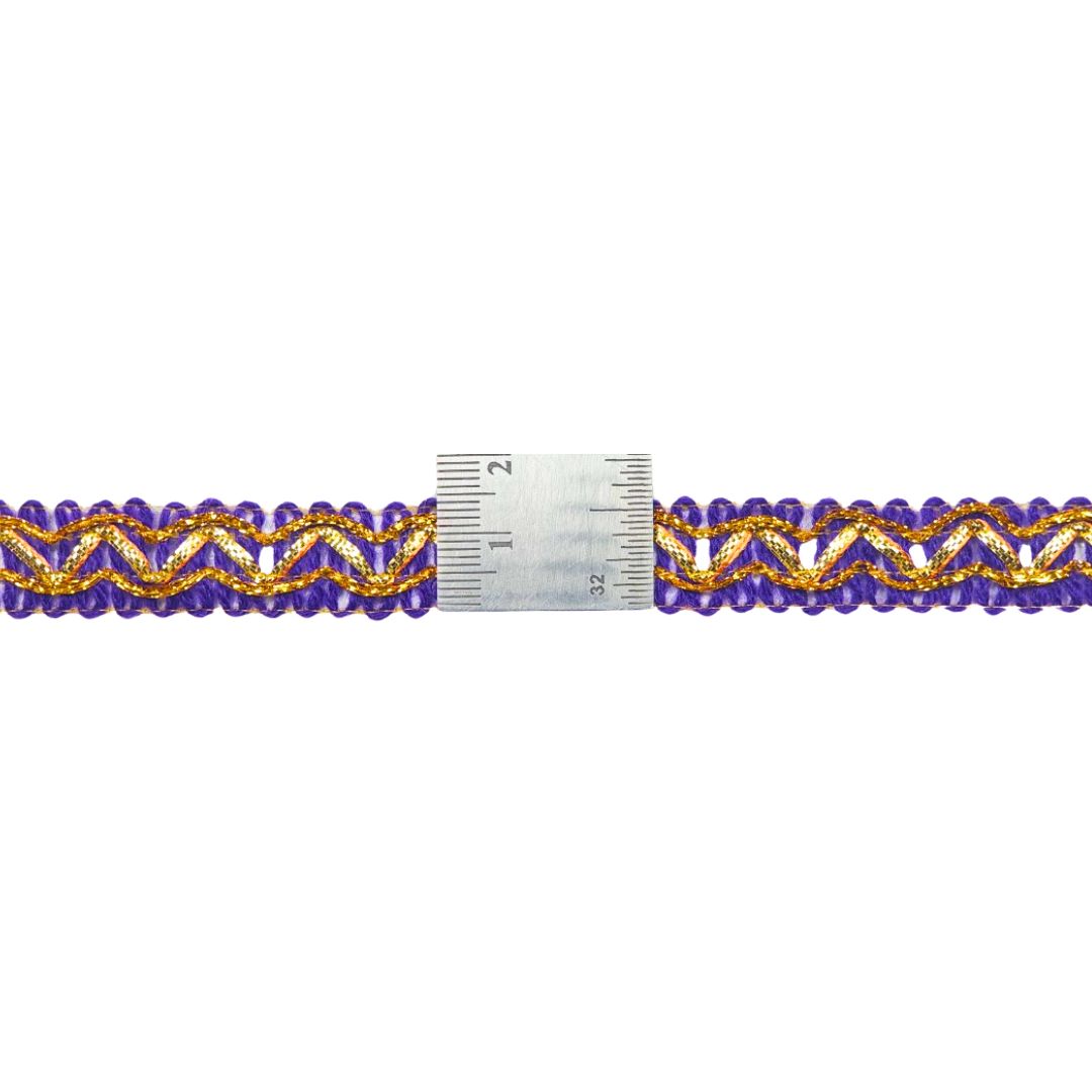 Purple and gold beaded trim with a ruler for scale on a white background