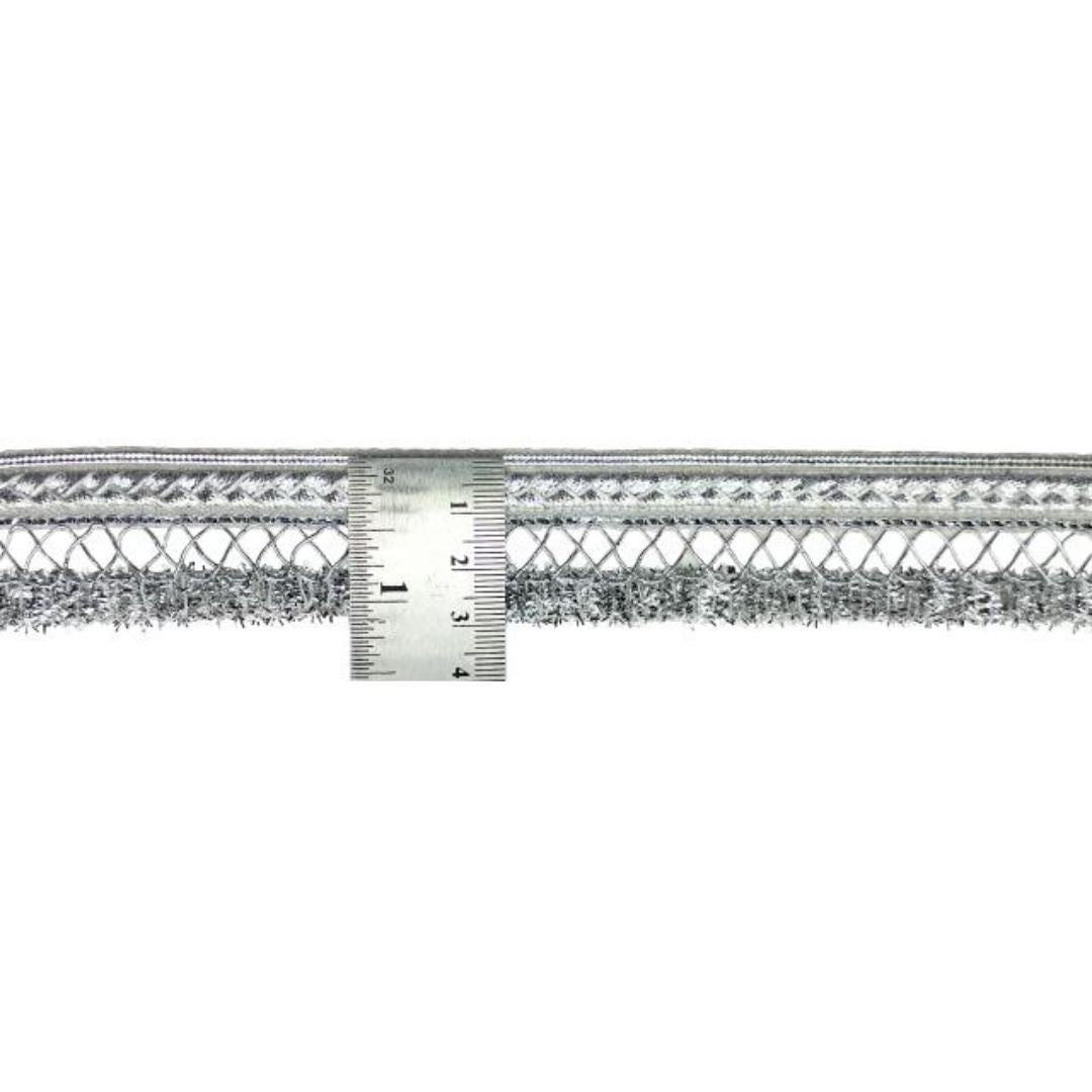 Metallic lace trim with a ruler for measurement on a white background