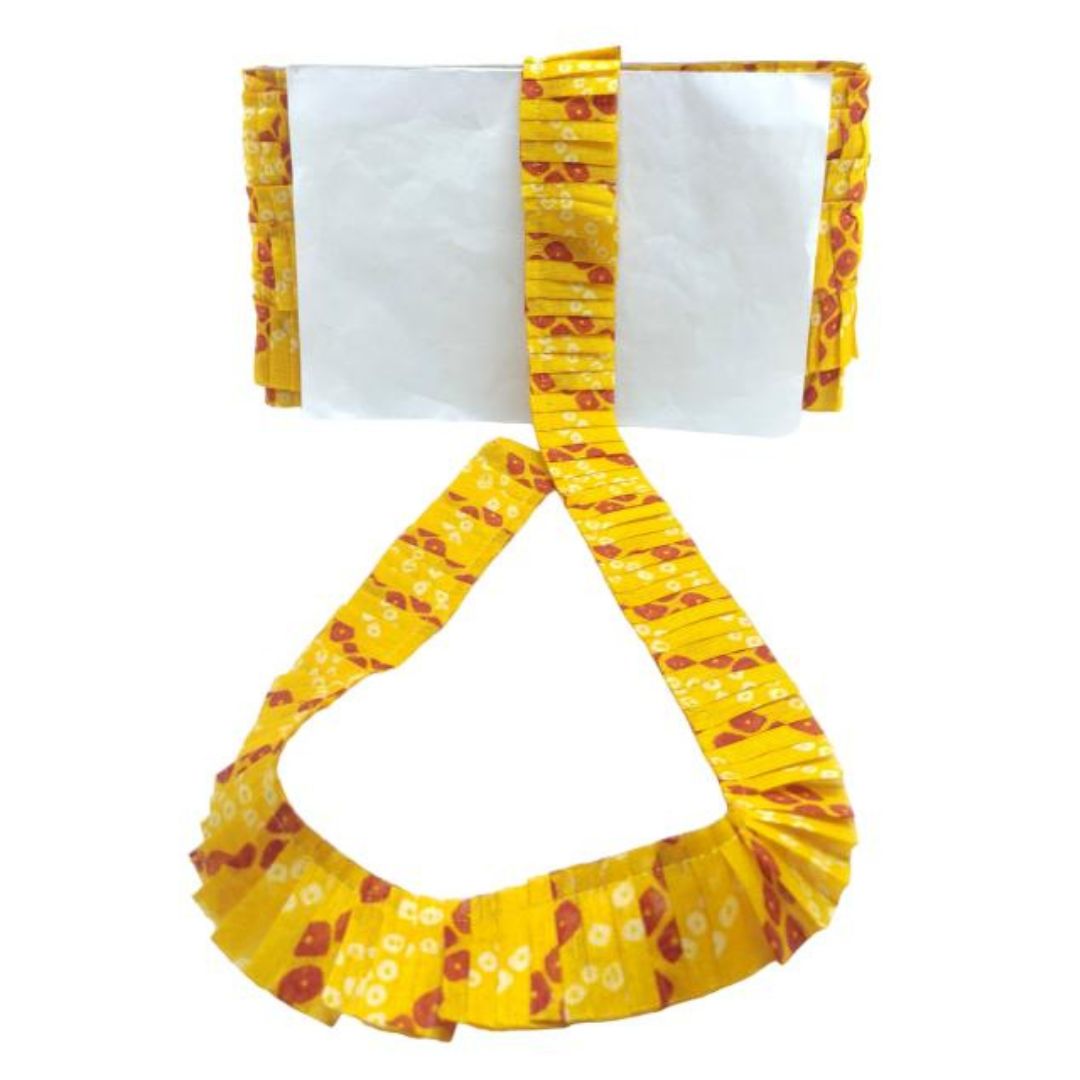 Yellow and red patterned fabric with a white center on a white background