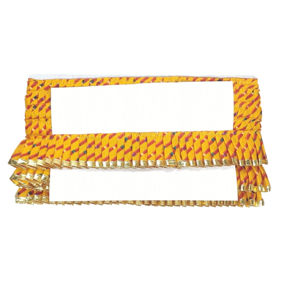 Yellow and red patterned fabric with gold trim on a white background