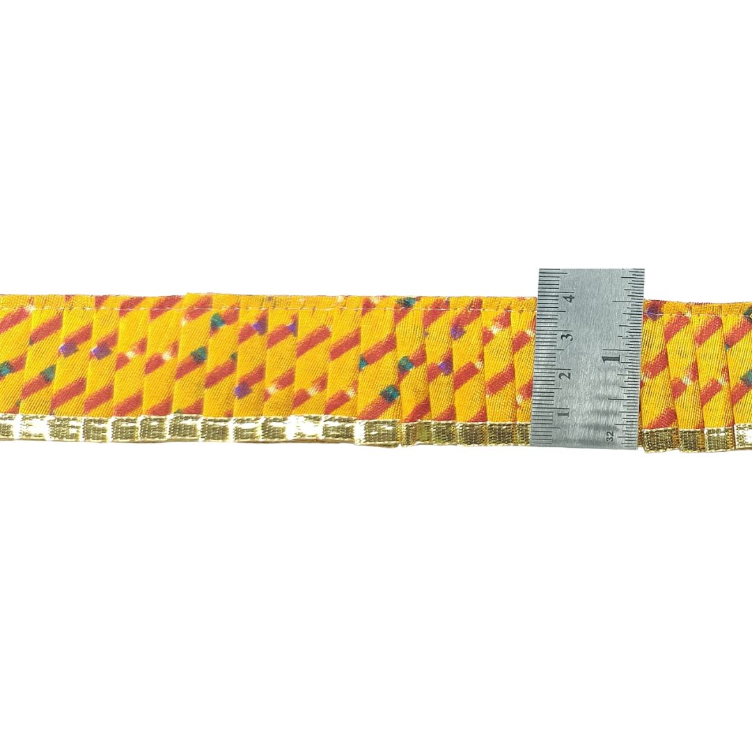 Yellow belt with a pattern and a ruler for size reference on a white background